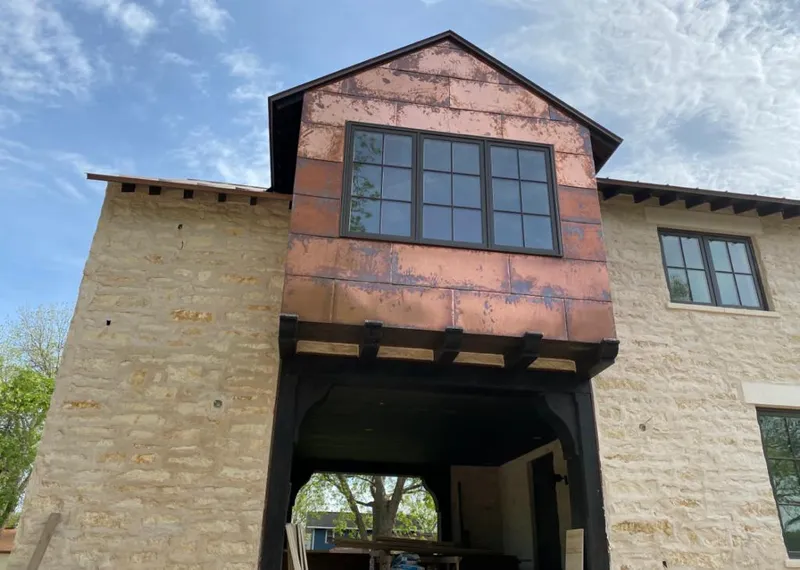 Copper metal panel facade on a stone building for Metal Roof Coating in Perry